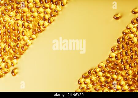 Capsules in a shell with fish oil on a yellow background and a place for text. Golden capsules with a biologically active supplement for health Stock Photo