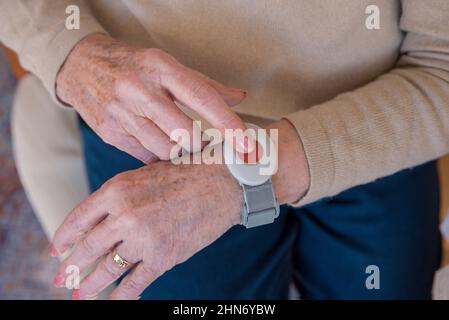 Senior hand pressing  emergency call button at home Stock Photo