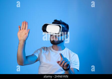 Young man developer, designer or architect working with a VR headset in a virtual space and create new products, applications or working on a new Stock Photo