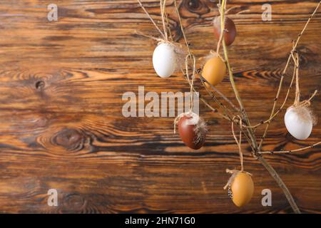Tree branch and Easter eggs on wooden background Stock Photo