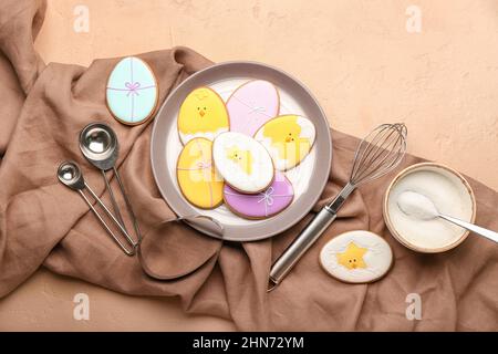 Composition with tasty Easter cookies in plate on color background Stock Photo