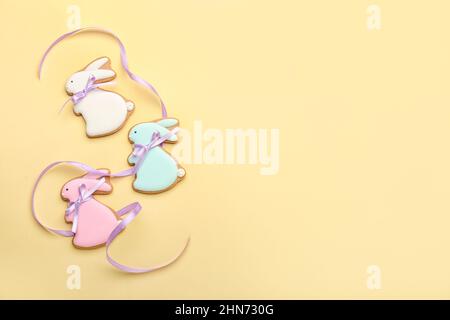 Delicious Easter cookies in shape of bunny on beige background Stock Photo
