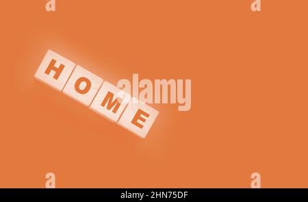 Wooden cubes with the word home, home on a black background. Real estate business or Emigration consept. Stock Photo