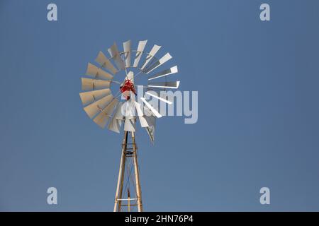 An old windmill against a blue sky in the town of Paralimni, Cyprus Stock Photo