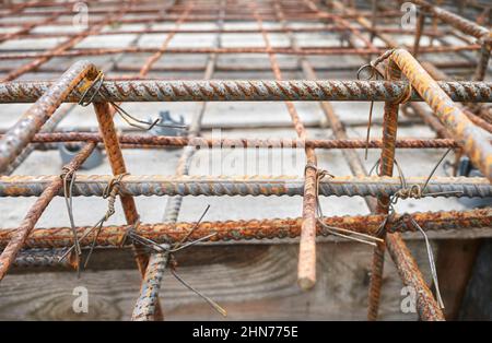 Close up picture of ribbed steel bar reinforcement construction ready for concrete casting, selective focus. Stock Photo