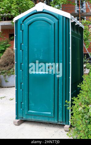 Green portable toilet or portable toilet on a construction site Stock Photo