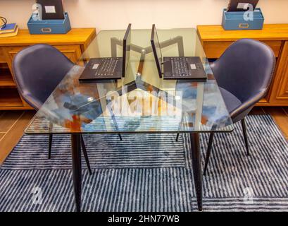 Home Office Glass Table With Two Laptops Stock Photo