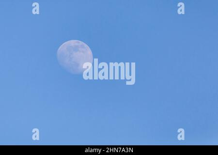 view of the waxing crescent moon in a blue sky Stock Photo