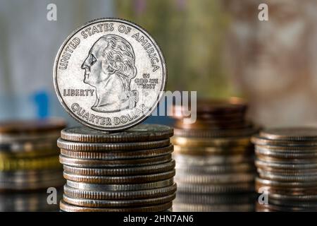 Inflation Interest Rates Quarter Dollar George Washington on top of Pile of Coins Stock Photo