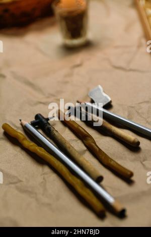 Tools for decorating Paschal eggs, Pysankas. Rustic background. Collection pens and pencils. Homemade pen for drawing eggs. Preparation for holiday Stock Photo