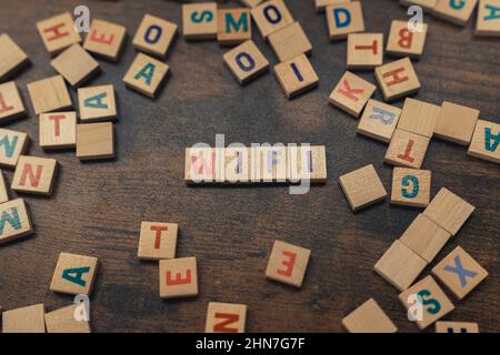 Wi-fi word made of scattered wooden alphabet letters - concept. High quality photo Stock Photo
