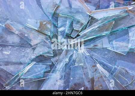 Broken glass on the ground, dirty shards of glass Stock Photo