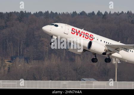 Zurich, Switzerland, February 10, 2022 Swiss International Airlines Bombardier CS-100 aircraft take off from runway 28 at the international airport Stock Photo