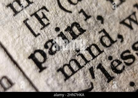 Definition of word pain on dictionary page, close-up Stock Photo