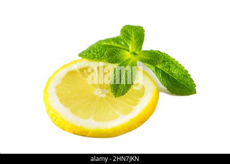 Fresh juicy lemon with mint on white background. Slice of ripe yellow citrus. Fruit high in vitamin C Stock Photo