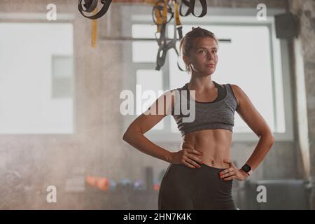 Young fit woman doing fitness exercises at gym Stock Photo