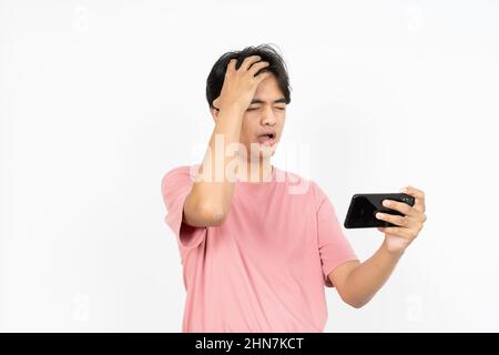 Playing Games On Smartphone Of  Asian man Isolated On White Background Stock Photo
