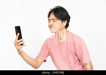 Asian man send love sign to girlfriend online in the smartphone application Stock Photo