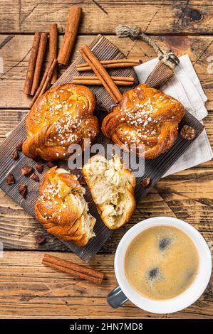 Breakfast with Cinnamon buns or rolls, Swedish Kanelbullar. wooden background. Top view Stock Photo