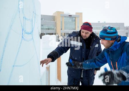 Installers at the construction site are talking Stock Photo