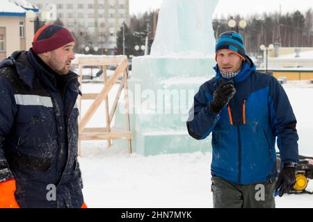 Installers at the construction site are talking Stock Photo