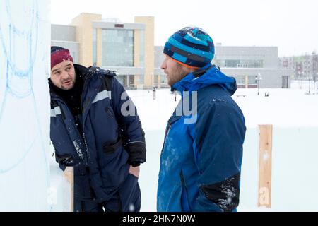 Installers at the construction site are talking Stock Photo