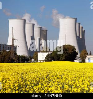 Panoramic view of Nuclear power plant Jaslovske Bohunice with golden flowering field of rapeseed - Slovakia - two possibility for production of electr Stock Photo