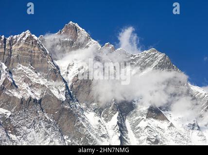 Top of Lhotse with clouds on the top - way to mount Everest base camp, Khumbu valley, Sagarmatha national park, Nepalese Himalayas Stock Photo