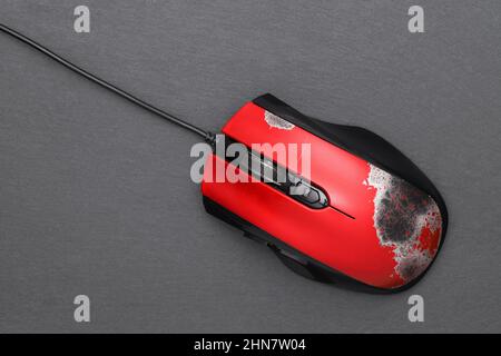 broken computer mouse with connection cable on dark gray background Stock Photo