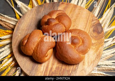 Delicious fresh baked crusty style knot bread rolls in assorted shapes including double knot and rosette Stock Photo