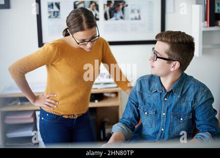 Problem-solving professionals at work. Shot of two colleagues working together in the office. Stock Photo