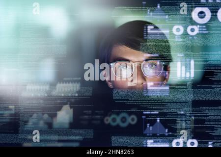 Shes a genius programmer. Cropped shot of a young computer programmer looking through data. Stock Photo