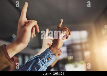 The greatest gift is not being afraid to question. Cropped shot of hands being raised to ask a question. Stock Photo