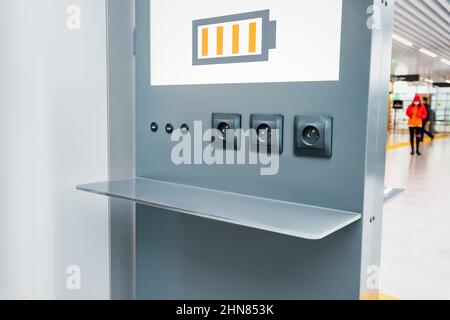 Free charging station for phones and personal gadgets of passengers at the airport Stock Photo