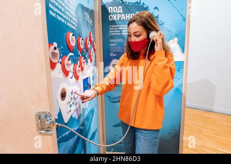 19 October 2021, Moscow, Russia: Woman hearing sounds of wildlife Stock Photo