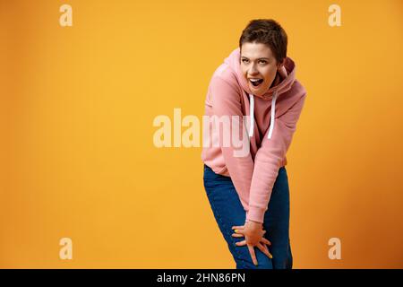 Young short-haired woman with weird expression iin studio Stock Photo