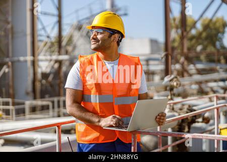 Photo of happy male multiethnic worker in plant Stock Photo