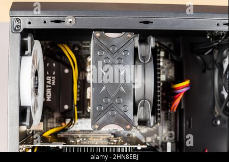 The contents of a desktop computer. The system unit of a modern computer with the side cover removed. Ukraine, Nikolaev - 02 09 2022. Stock Photo