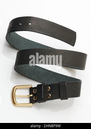 Spiral shape black leather belt isolated on studio background Stock Photo