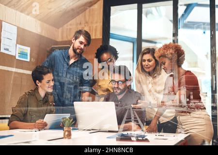 Combining their skills and efforts to drive success forward. Multiple exposure shot of businesspeople having a meeting superimposed over a cityscape. Stock Photo
