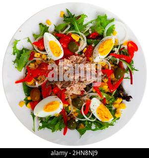 Corn, olive, anchovy, pepper, lettuce salad served on plate Stock Photo