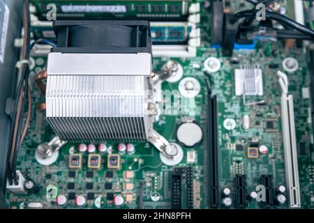 Woodville, Australia - October 15, 2021: Close-up top view of CPU cooler installed in business desktop PC motherboard Stock Photo
