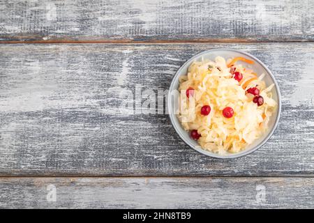 sauerkraut, marinated cabbage on a blue ceramic plate on a gray wooden background. Top view, flat lay, close up, copy space. Stock Photo