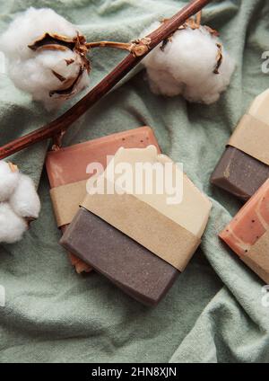 Handmade natural organic soap bars and cotton flowers on textile background Stock Photo