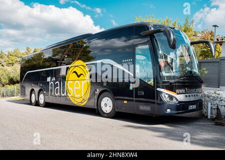 25 October 2021, Nikiti, Greece: Tourist coach with Hauser Tour operator logo on a bus Stock Photo