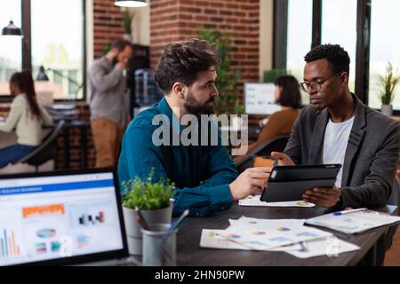 Multiracial team planning business collaboration analyzing marketing strategy working at financial project in startup office. Diverse businesspeople brainstorming ideas planning collaboration Stock Photo