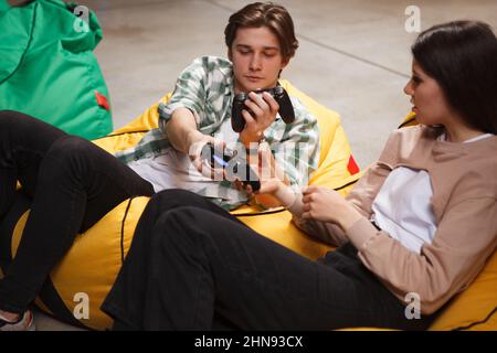 Premium Photo  Man gamer teaching his girlfriend playing space shooter  video game on rgb powerful personal computer. pro cyber woman with headset  performing video games streaming from home during online tournament