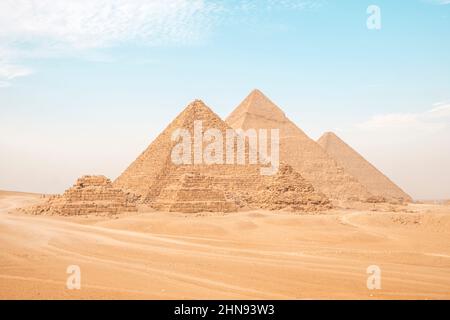 Egypt. Cairo - Giza. General view of pyramids from the Giza Plateau. three pyramids known as Queens' Pyramids, in background: the Pyramid of Menkaure Stock Photo