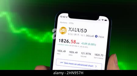 Kharkov, Ukraine - February 11, 2022: XAU USD gold stock trade price chart, green finance background. Logo closeup Stock Photo