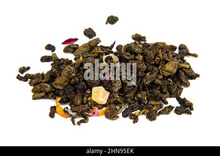 Aromatic green dried tea leaves with mango isolated on the white background Stock Photo